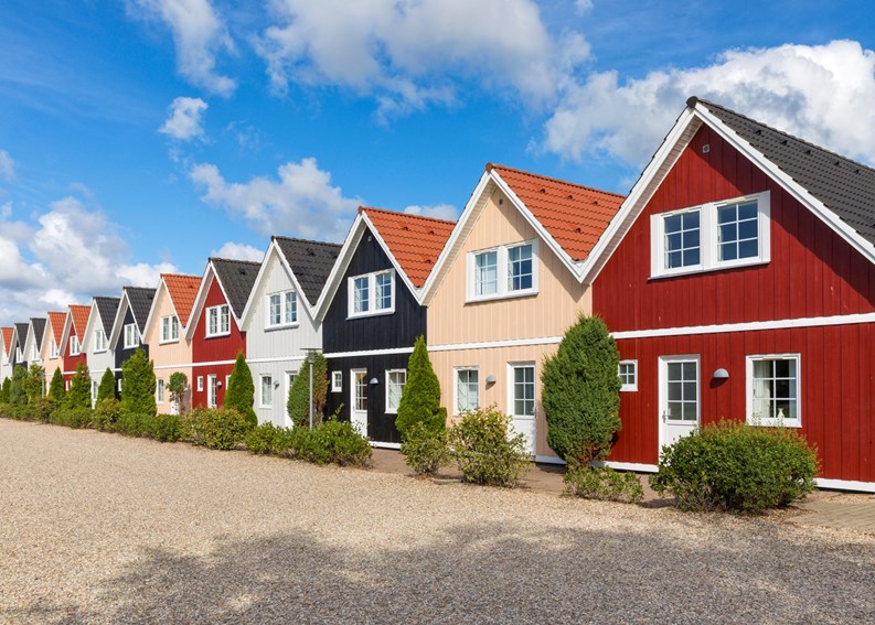 Row of almost identical wooden holiday cottages in Denmark
